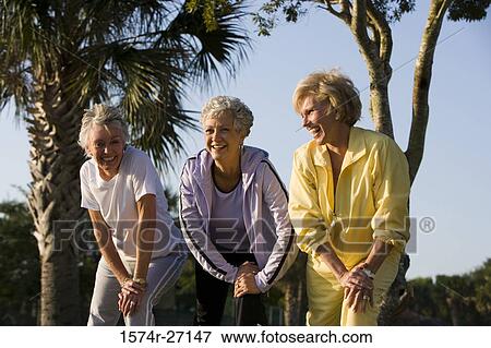 Cheerful senior woman exercising with hand on knee View Large Photo Image Stock Photo - Cheerful senior woman exercising with hand on knee. Fotosearch