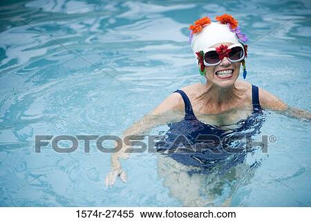 Cheerful senior women smiling and swimming in a swimming pool View Large Photo Image Stock Photography - Cheerful senior women smiling and swimming in a swimming pool. Fotosearch