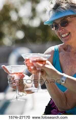 Cheerful senior women toasting drinks View Large Photo Image Stock Image - Cheerful senior women toasting drinks. Fotosearch