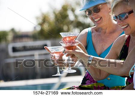 Cheerful senior women toasting drinks View Large Photo Image Stock Photo - Cheerful senior women toasting drinks. Fotosearch