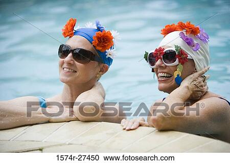 Cheerful senior women wearing sunglasses in a swimming pool View Large Photo Image Stock Image - Cheerful senior women wearing sunglasses in a swimming pool. Fotosearch