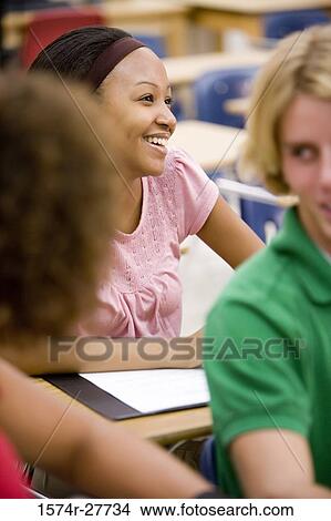 Picture - Cheerful students in the classroom. Fotosearch