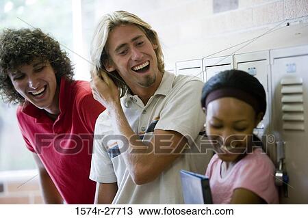 Cheerful students standing by lockers in corridor View Large Photo Image Stock Image - Cheerful students standing by lockers in corridor. Fotosearch