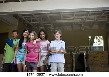 Cheerful teenagers standing together and holding brushes in the petting zoo View Large Photo Image Stock Image - Cheerful teenagers standing together and holding brushes in the petting zoo. Fotosearch