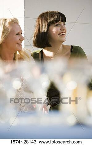 Stock Image - Cheerful women looking away. Fotosearch