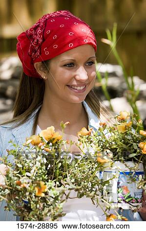 Cheerful young woman with bunch of flower View Large Photo Image Stock Photography - Cheerful young woman with bunch of flower. Fotosearch