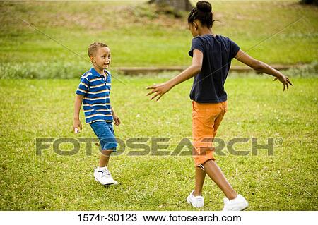 Stock Image - Children playing at park. Fotosearch