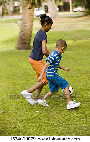 Children playing soccer ball at park View Large Photo Image Stock Photo - Children playing soccer ball at park. Fotosearch
