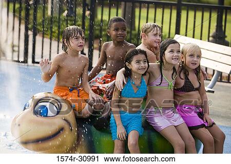 Stock Image - Children sitting on a tortoise sculpture. Fotosearch