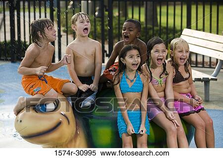Stock Photography - Children sitting on a tortoise sculpture. Fotosearch