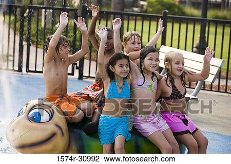 Children sitting on a tortoise sculpture with arms raised View Large Photo Image Stock Image - Children sitting on a tortoise sculpture with arms raised. Fotosearch