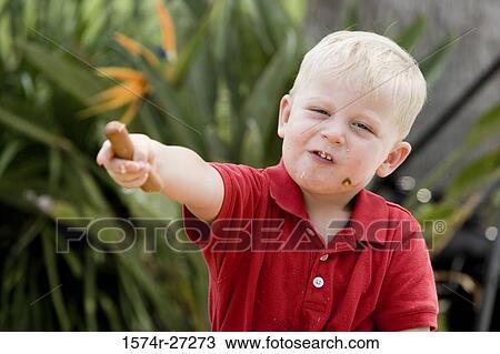 Close-up of a boy holding hot dog View Large Photo Image Stock Image - Close-up of a boy holding hot dog. Fotosearch