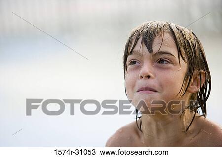 Stock Image - Close-up of a boy making faces. Fotosearch