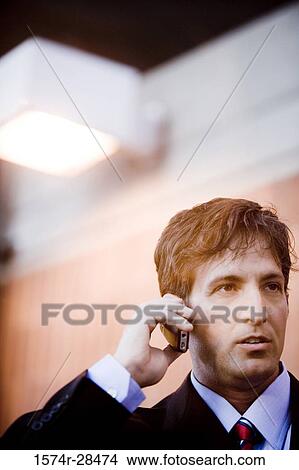 Picture - Close-up of a businessman using cellphone. Fotosearch