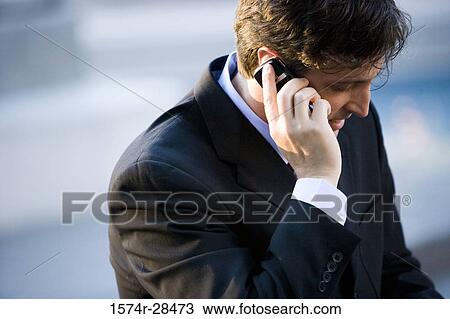 Stock Image - Close-up of a businessman using cellphone. Fotosearch