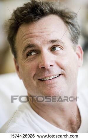 Close-up of a cheerful mid adult man View Large Photo Image Stock Photograph - Close-up of a cheerful mid adult man. Fotosearch