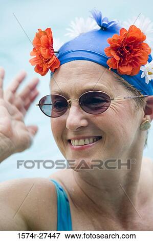 Close-up of a cheerful senior woman wearing sunglasses in a swimming pool View Large Photo Image Stock Photo - Close-up of a cheerful senior woman wearing sunglasses in a swimming pool. Fotosearch