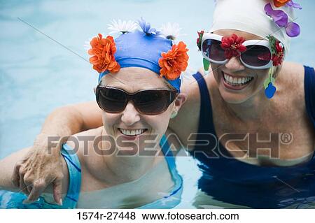 Close-up of a cheerful senior women wearing sunglasses in a swimming pool View Large Photo Image Stock Photo - Close-up of a cheerful senior women wearing sunglasses in a swimming pool. Fotosearch