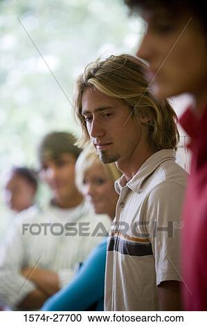 Close-up of a contemplative male student with his friends in secondary school building View Large Photo Image Stock Image - Close-up of a contemplative male student with his friends in secondary school building. Fotosearch