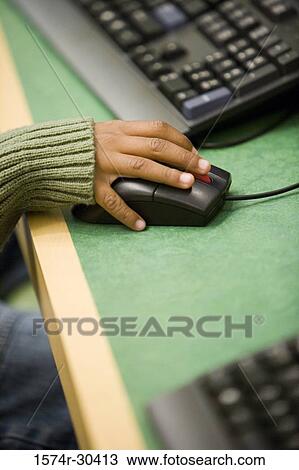 Stock Image - Close-up of a hand holding a computer mouse. Fotosearch