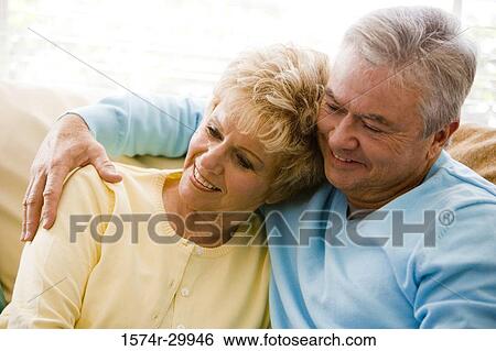 Close-up of a mature couple smiling View Large Photo Image Stock Photograph - Close-up of a mature couple smiling. Fotosearch