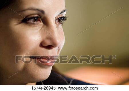 Stock Photography - Close-up of a mature woman smiling and looking away. Fotosearch