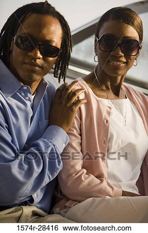 Close-up of a mid adult couple sitting in the boat View Large Photo Image Stock Photograph - Close-up of a mid adult couple sitting in the boat. Fotosearch