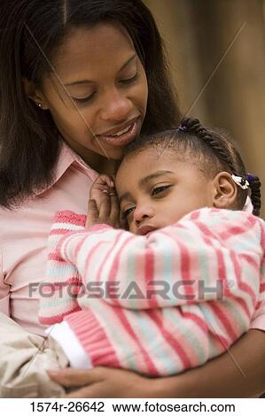 Close-up of a mother carrying her daughter View Large Photo Image Stock Image - Close-up of a mother carrying her daughter. Fotosearch