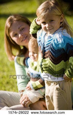 Stock Image - Close-up of a mother with her children smiling. Fotosearch