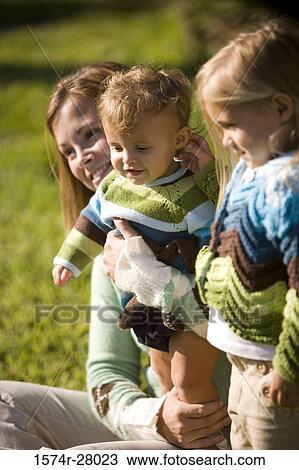Close-up of a mother with her children smiling View Large Photo Image Stock Image - Close-up of a mother with her children smiling. Fotosearch