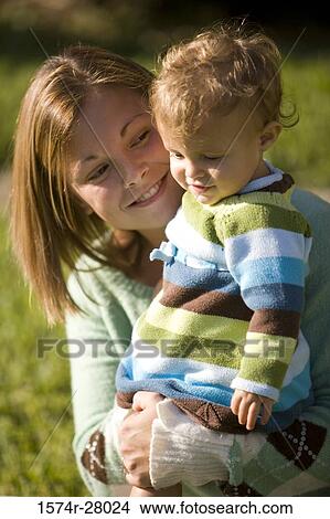 Picture - Close-up of a mother with her son smiling. Fotosearch