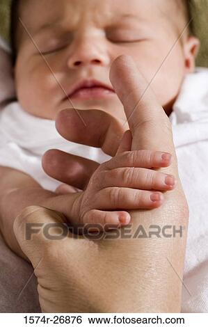 Close-up of a newborn baby holding hand View Large Photo Image Stock Photograph - Close-up of a newborn baby holding hand. Fotosearch