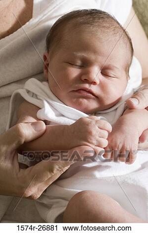 Close-up of a newborn baby in human hand View Large Photo Image Stock Image - Close-up of a newborn baby in human hand. Fotosearch