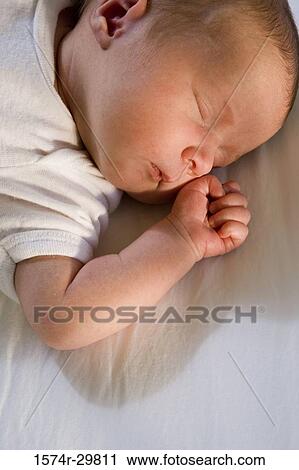 Close-up of a newborn baby sleeping View Large Photo Image Stock Image - Close-up of a newborn baby sleeping. Fotosearch