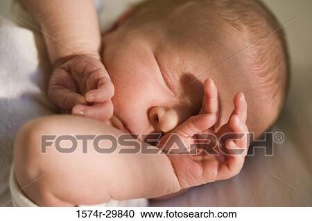 Close-up of a newborn baby sleeping View Large Photo Image Stock Image - Close-up of a newborn baby sleeping. Fotosearch