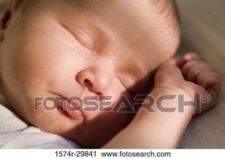 Close-up of a newborn baby sleeping View Large Photo Image Stock Image - Close-up of a newborn baby sleeping. Fotosearch