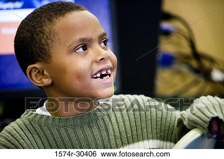 Close-up of a schoolboy smiling in the library View Large Photo Image Stock Photograph - Close-up of a schoolboy smiling in the library. Fotosearch