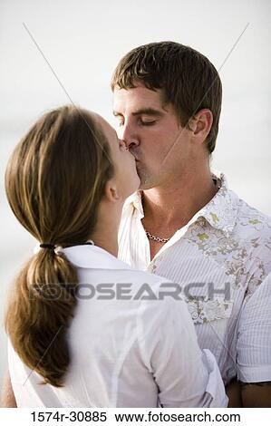 Close-up of a young couple kissing View Large Photo Image Stock Photography - Close-up of a young couple kissing. Fotosearch