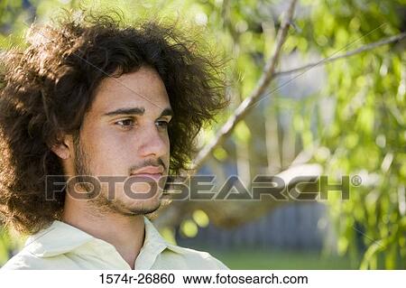 Stock Image - Close-up of a young man looking away. Fotosearch