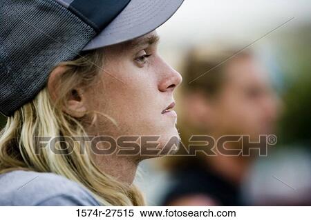 Close-up of a young man wearing a cap View Large Photo Image Stock Photography - Close-up of a young man wearing a cap. Fotosearch