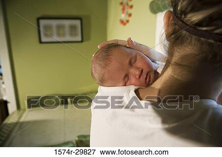Stock Photo - Close-up of a young woman holding her baby. Fotosearch