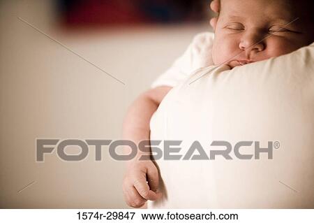 Stock Photo - Close-up of a young woman holding her baby. Fotosearch