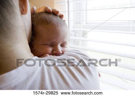 Close-up of a young woman holding her baby View Large Photo Image Stock Photography - Close-up of a young woman holding her baby. Fotosearch