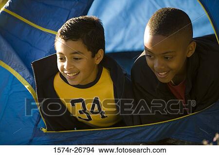 Close-up of friends looking through tent View Large Photo Image Picture - Close-up of friends looking through tent. Fotosearch