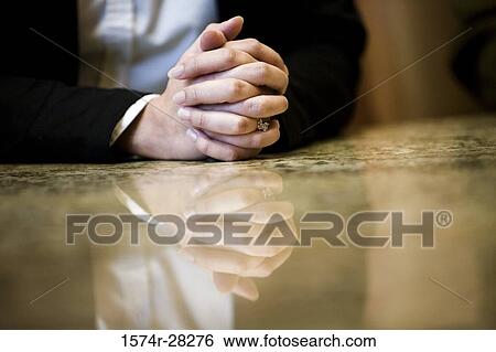 Close-up of human hands on conference table in an office View Large Photo Image Stock Photograph - Close-up of human hands on conference table in an office. Fotosearch