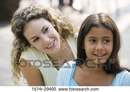 Close-up of mother and daughter sitting together View Large Photo Image Stock Image - Close-up of mother and daughter sitting together. Fotosearch