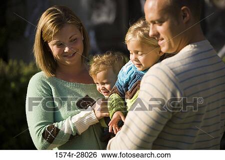 Close-up of parents with their children smiling View Large Photo Image Stock Photograph - Close-up of parents with their children smiling. Fotosearch