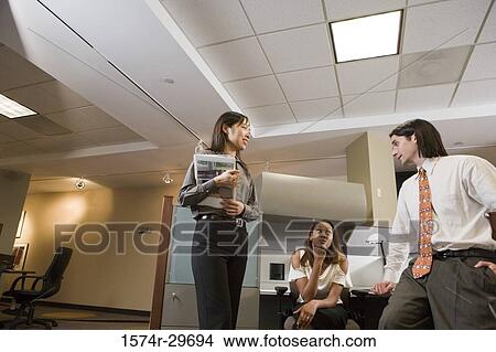 Picture - Colleagues discussing in an office. Fotosearch