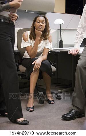 Colleagues discussing in an office View Large Photo Image Stock Image - Colleagues discussing in an office. Fotosearch