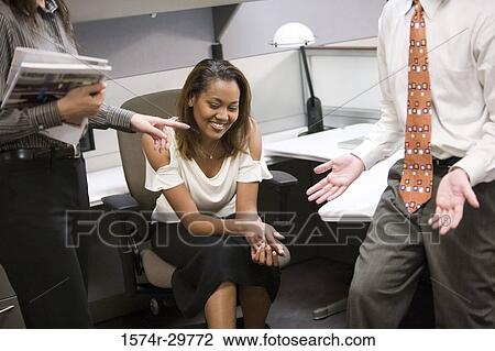 Colleagues discussing in an office View Large Photo Image Stock Image - Colleagues discussing in an office. Fotosearch
